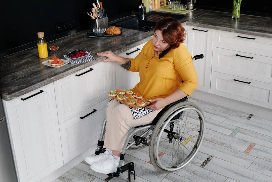 Person dragging a kitchen knife blade at a low angle across the rough unglazed ring on the bottom of an upside-down coffee mug on a countertop