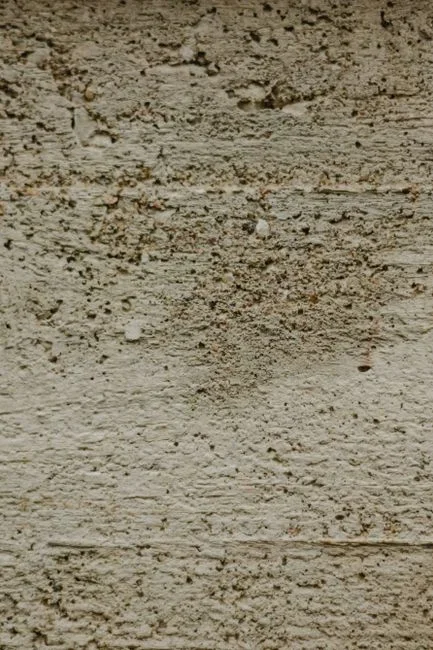 Close-up of the rough unglazed ceramic foot ring on the base of an overturned white coffee mug