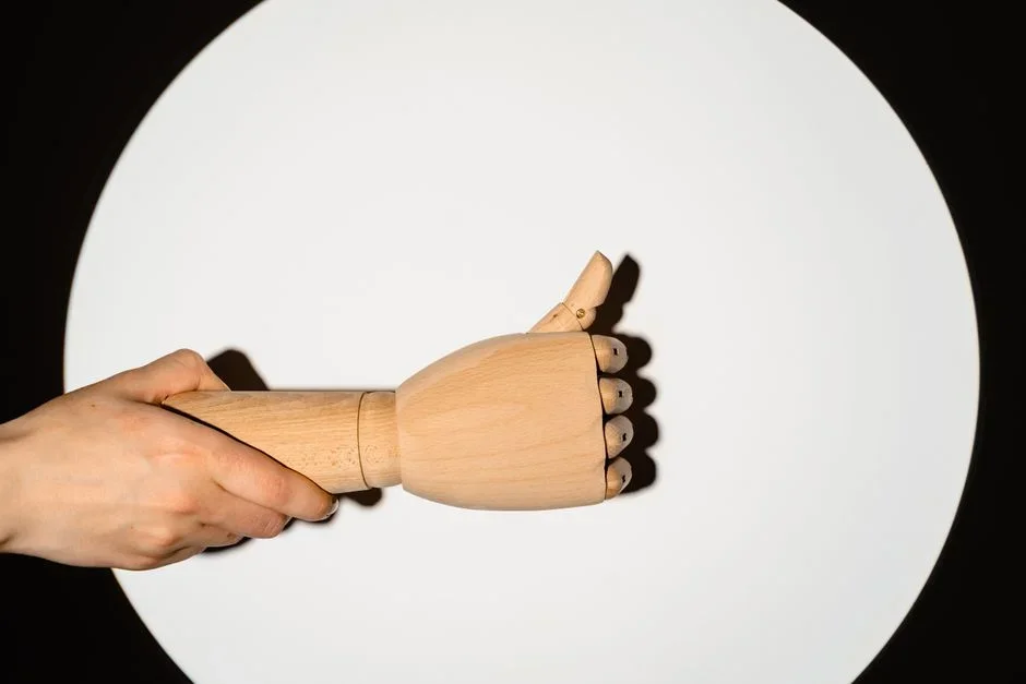Hand running a thumb along the edge of a kitchen knife to feel for a metal burr after sharpening on a wet whetstone
