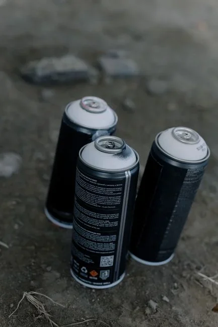 Aerosol total release fogger canister standing on a bedroom floor near an electrical outlet with warning label visible