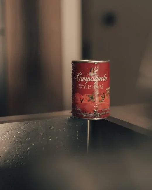 Aerosol bug bomb fogger can standing on a kitchen floor with its warning label facing the camera