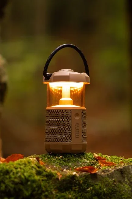 Rechargeable LED lantern and headlamp beside a portable battery power station on a kitchen counter, ready for a power outage